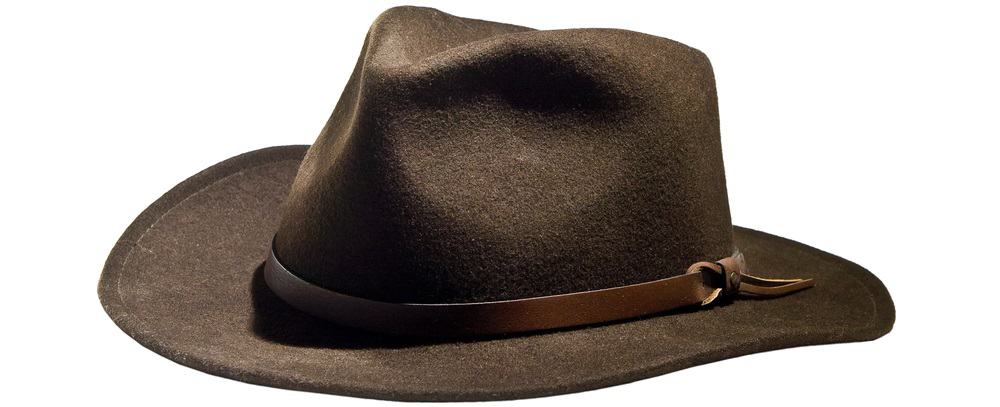 A close look at a brown fedora hat with a brown leather band.