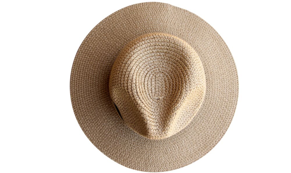 This is a top view of a straw fedora hat with a dark band.