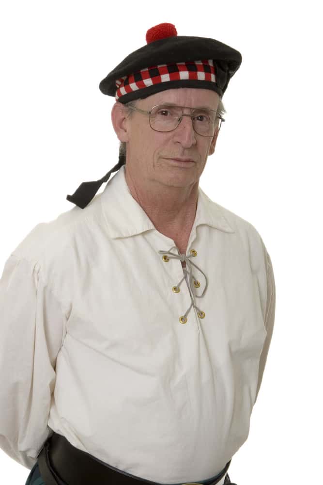 This is a man wearing a traditional Scottish sailor costume topped with a Glengarry bonnet.