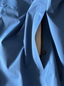 Close up view of side zipper pocket of Canada Goose rain jacket