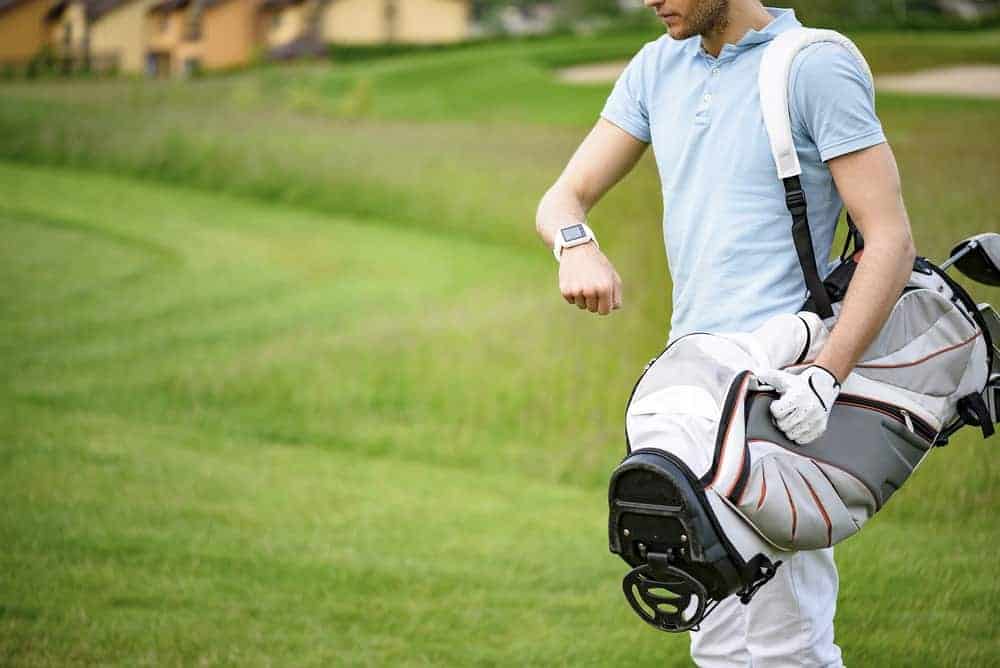 Golfer looking at his smartwatch.