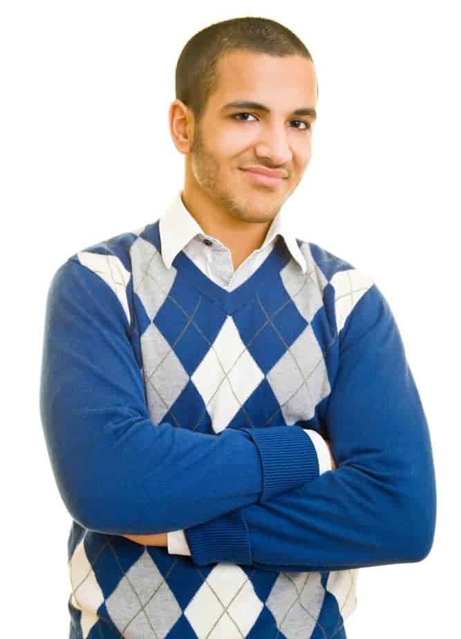 Man in crossed arms with blue argyle knit sweater.