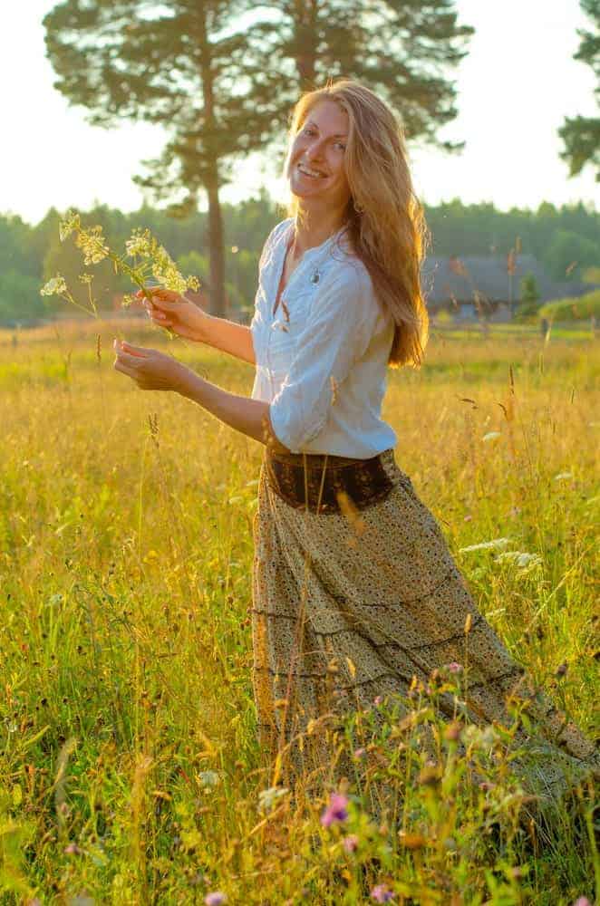 Woman wearing a white blouse and long yellow gypsy skirt.