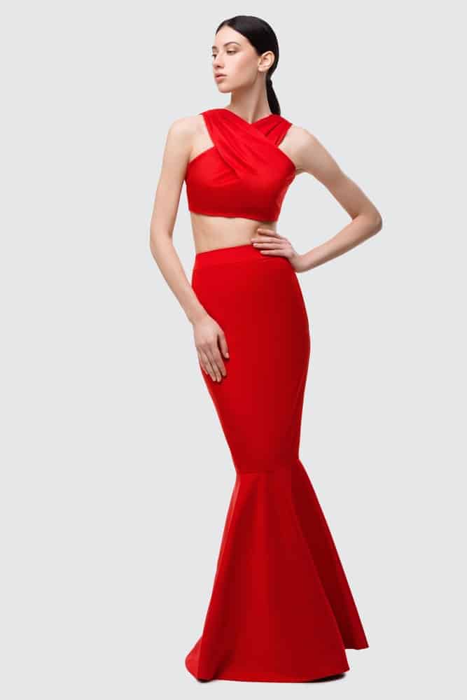 Woman wearing a red mermaid gown.