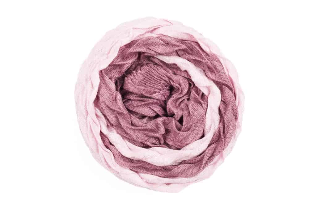 A lovely linen scarf rolled like a rose.