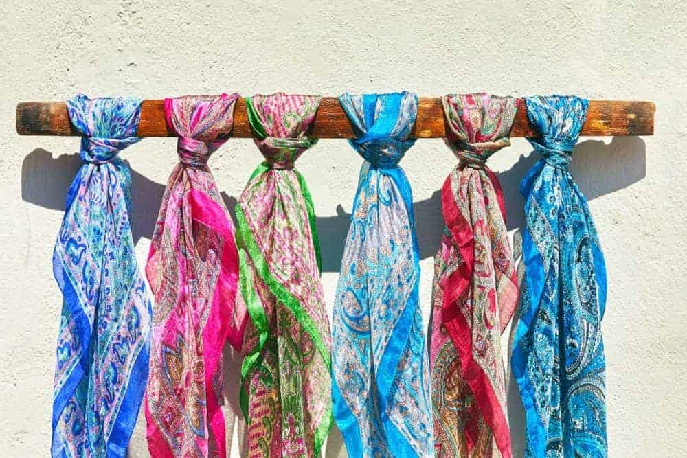 Six colorful silk scarves with intricate designs.