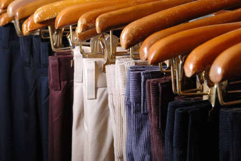 A close look at a rack of various pants.