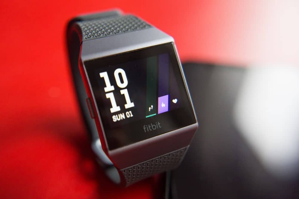 Fitbit ionic smartwatch against the red background