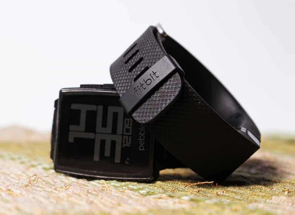 A close look at a couple of Fitbit Versa 2 with black sporty straps.