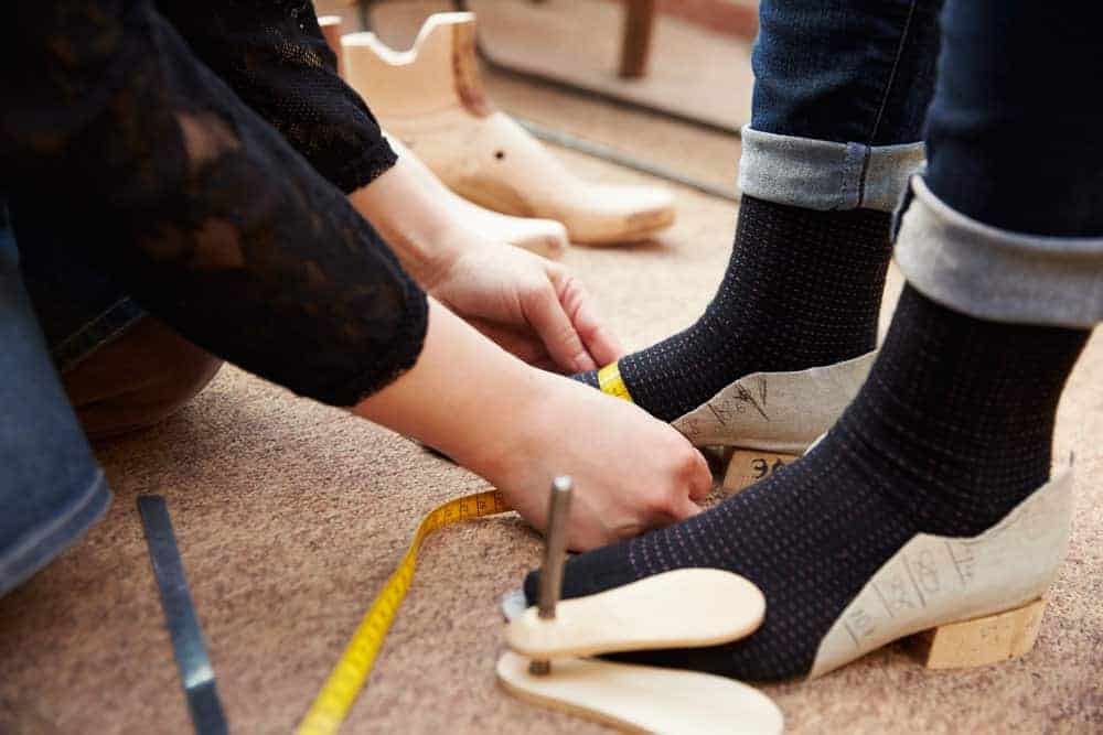 Measuring woman's foot for shoes