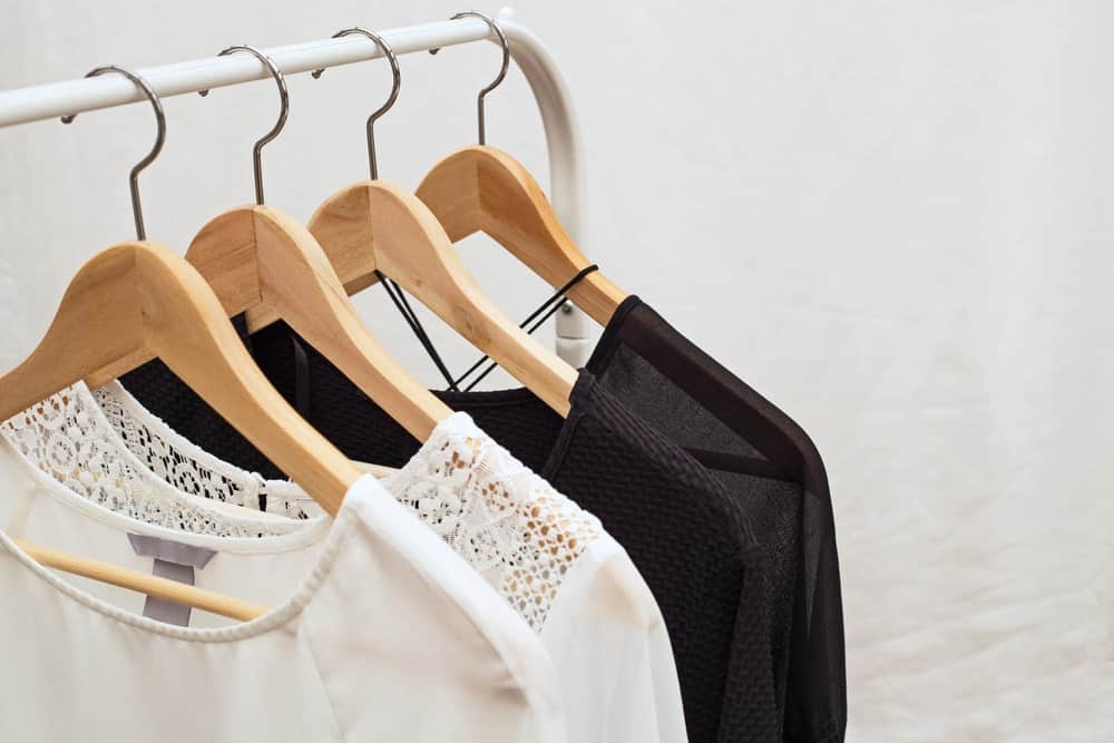 A close look at different blouses for women on display on a rack.