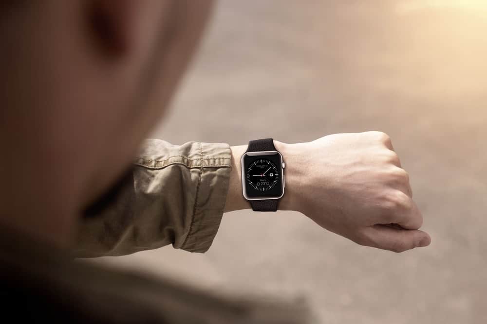 A close look at a man checking his smartwatch.