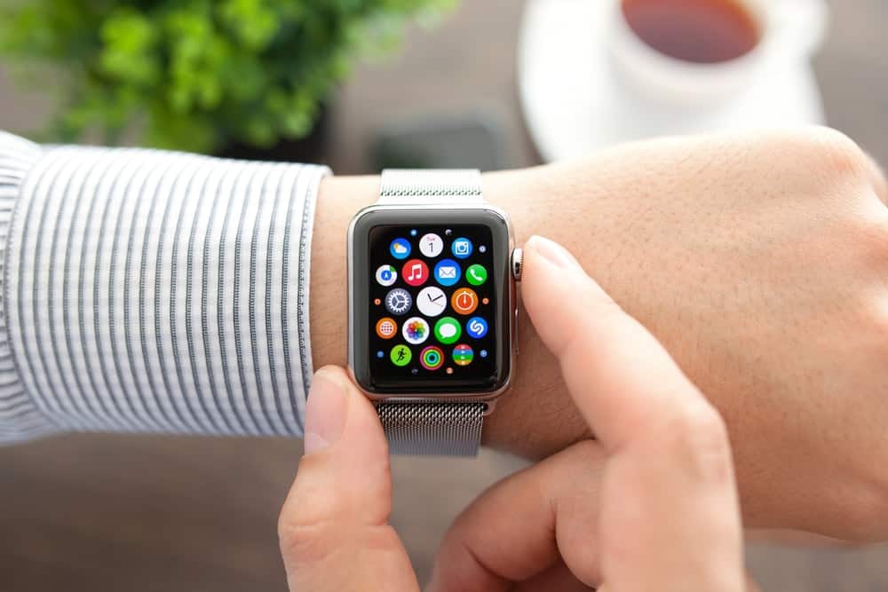 A close look at a man browsing the apps on his smartwatch.