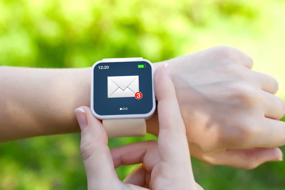 A close look at a woman checking her email on her smartwatch.