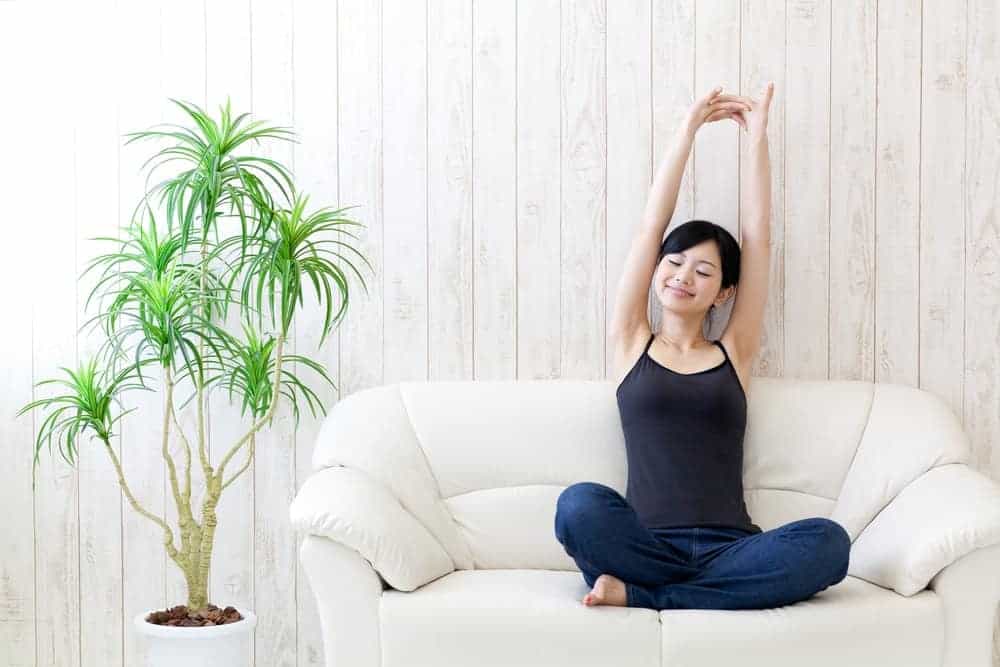 A woman wearing comfortable camisoles while relaxing on the couch.