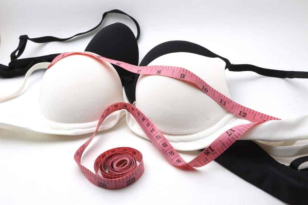 A black and a white bra with a tape measure.