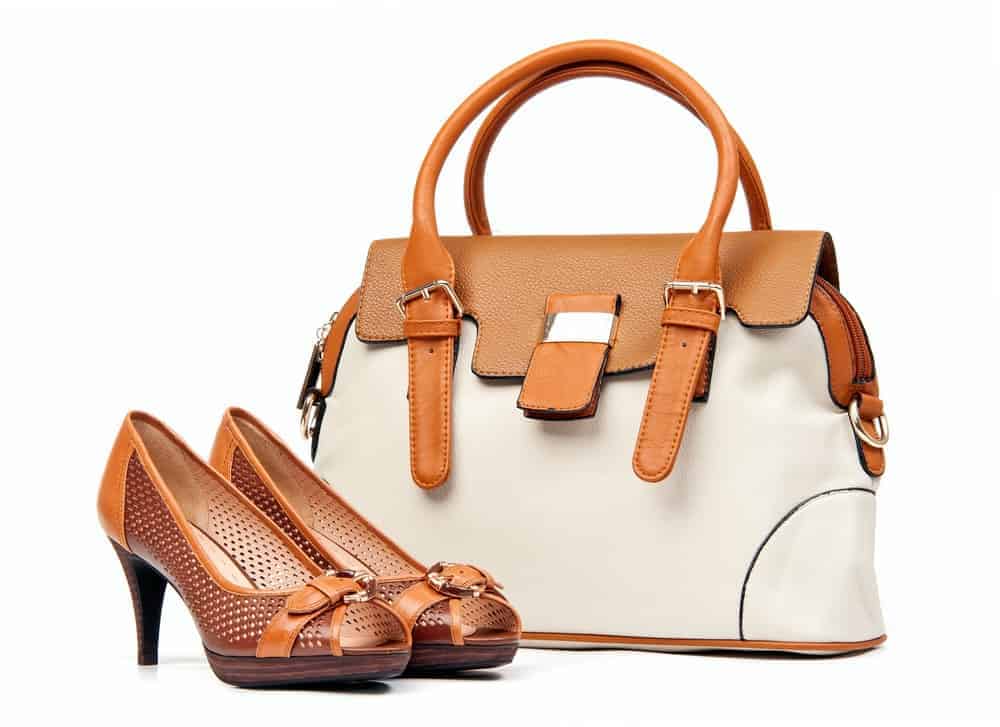 A pair of leather high-heeled shoes that matches the handbag.
