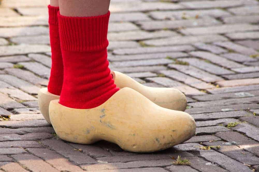 This is a close look at a woman wearing a pair of Dutch wooden clogs.