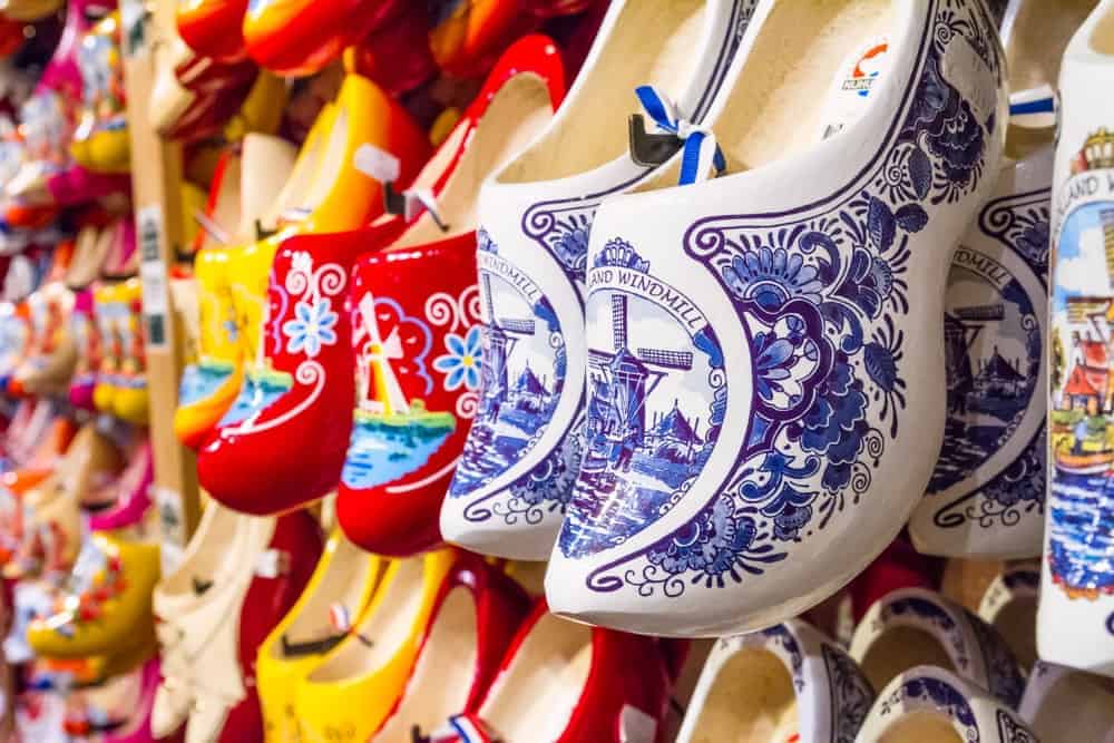 Various colorful Dutch clogs on display at a store.