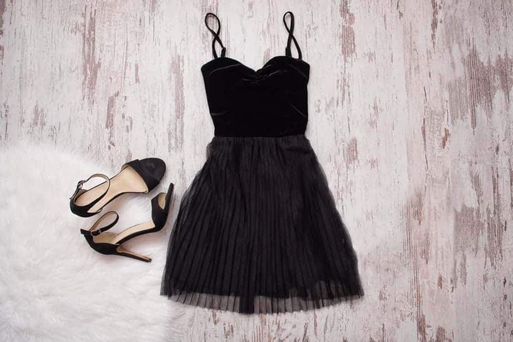 A little black dress with matching high-heeled sandals.