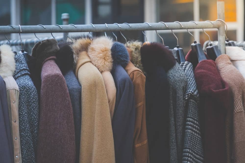 A close look at a rack of different coats.