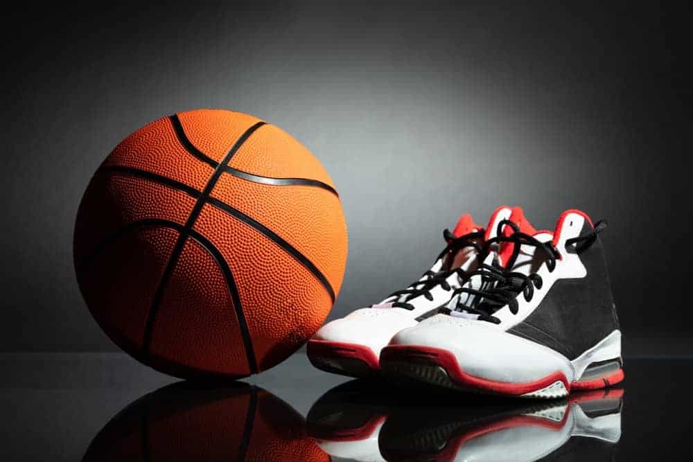 A pair of black and white basketball shoes with a basketball.