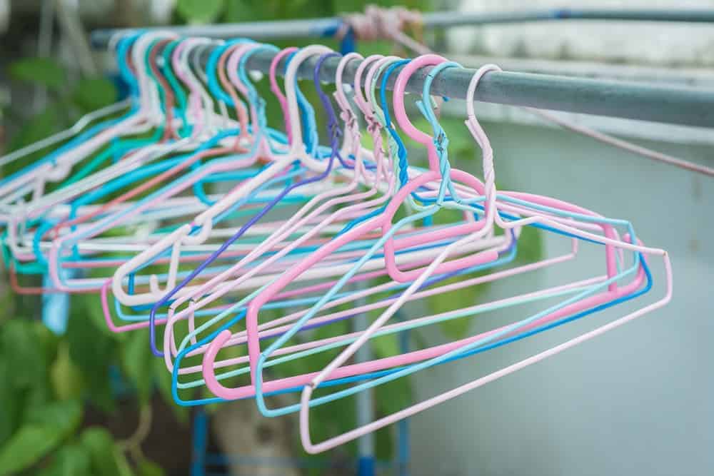 A close look at a set of colorful wire hangers.