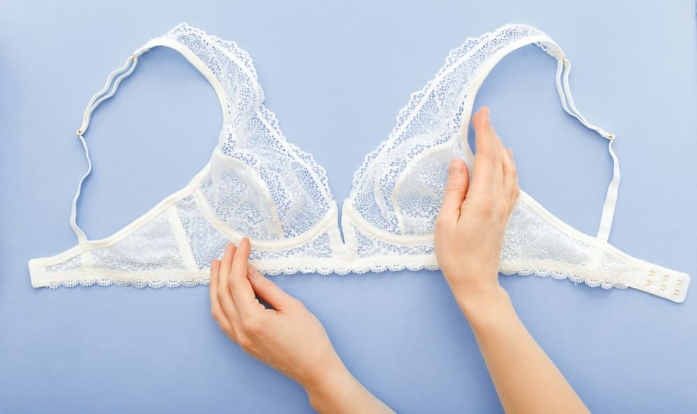 A close look at a piece of white lace unlined bra.