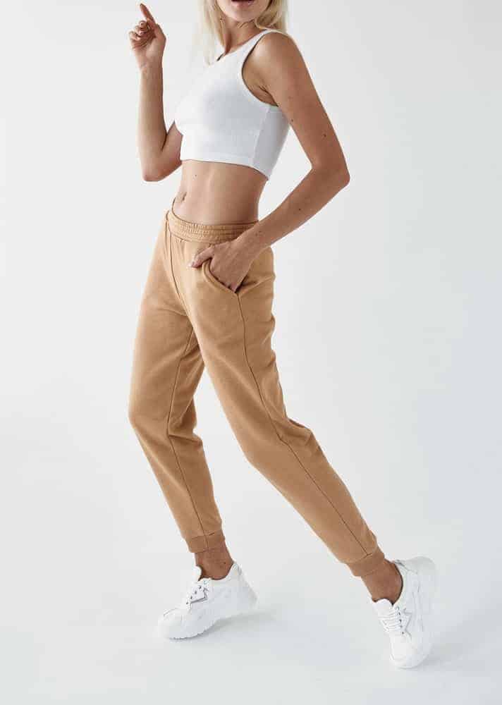 A woman wearing a pair of khaki joggers.