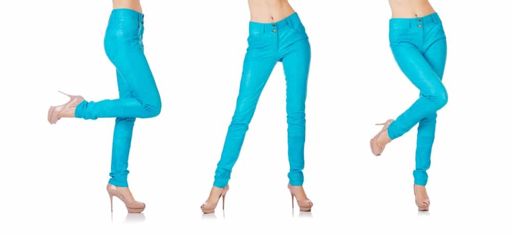 A woman modelling a pair of bright blue jeggings.