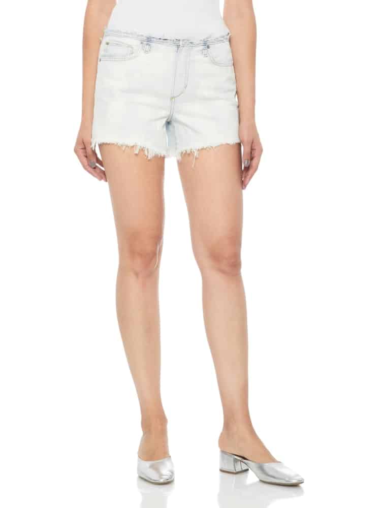 A close look at a woman wearing frayed denim shorts.