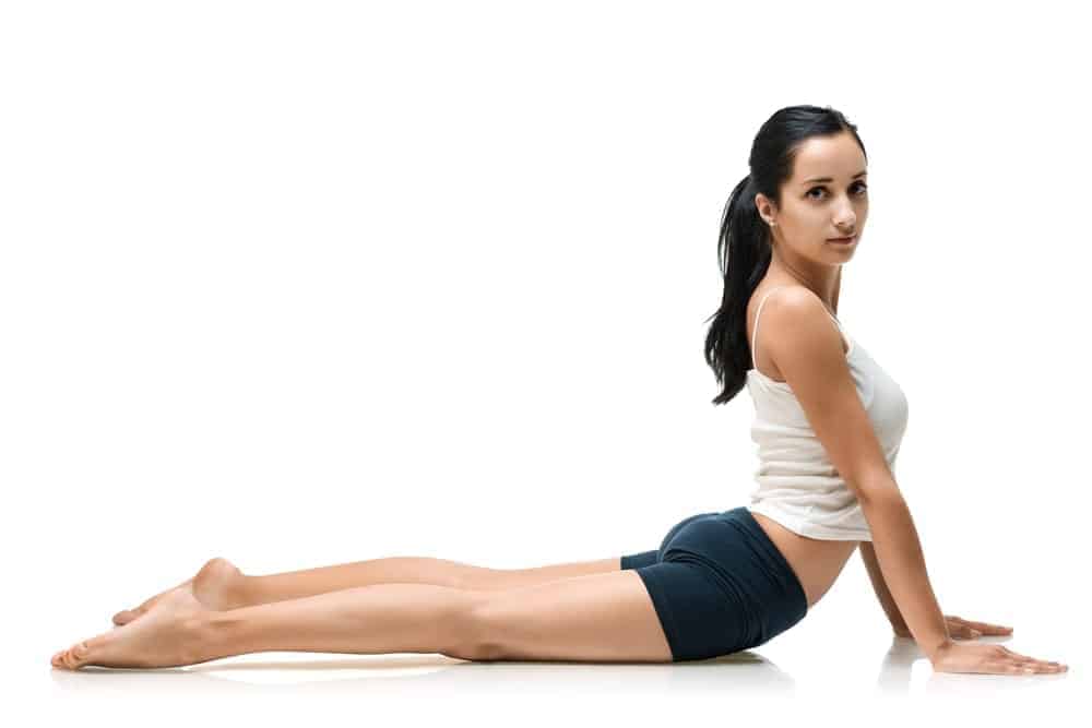 A woman wearing yoga shorts while doing a yoga position.