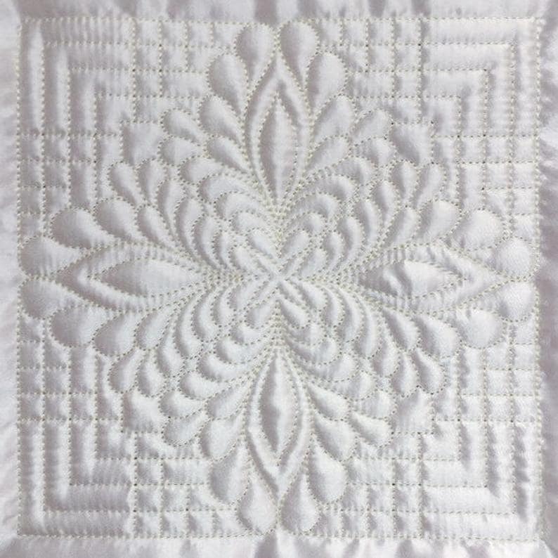 A Trapunto feather quilt from Etsy.
