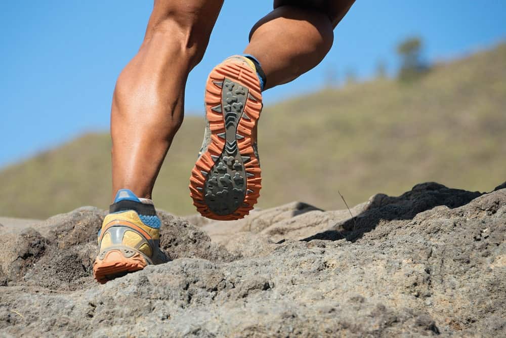 A runner wearing a pair of trail runner shoes.