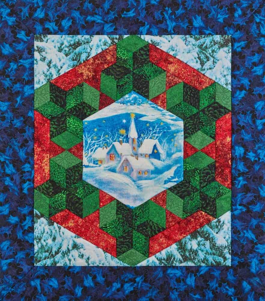 A colorful medallion quilt with a snowy landscape.