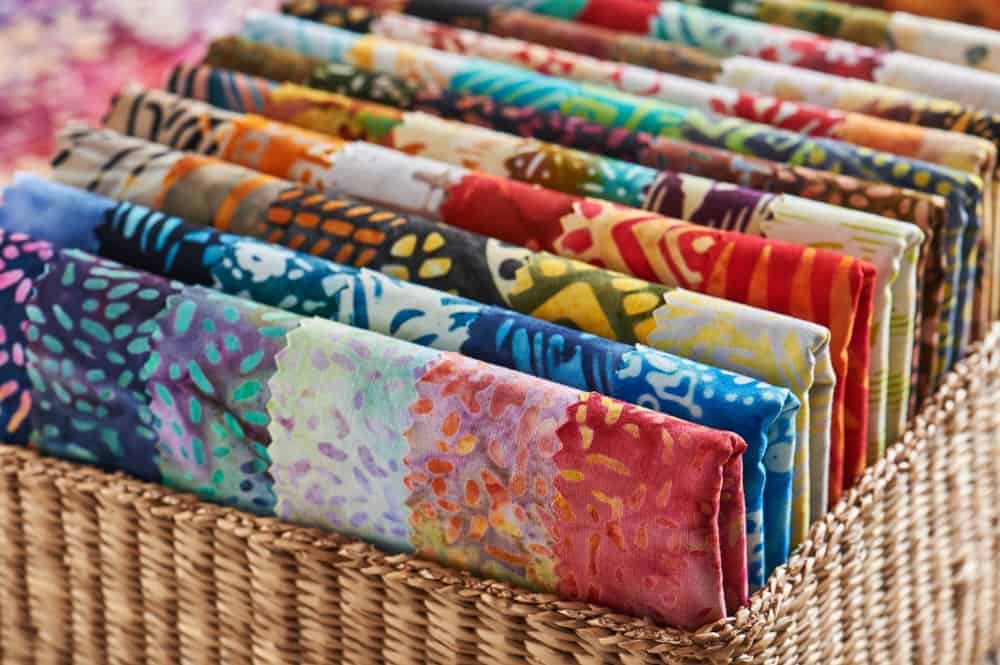 A basket of colorful quilts.