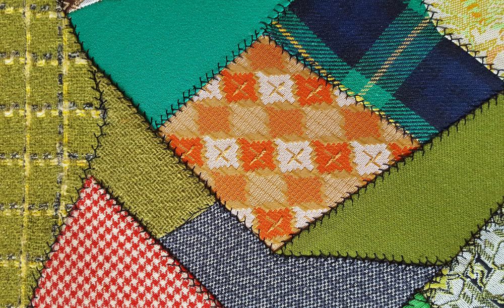 A close look at the crazy patchwork quilt with colorful patterns.