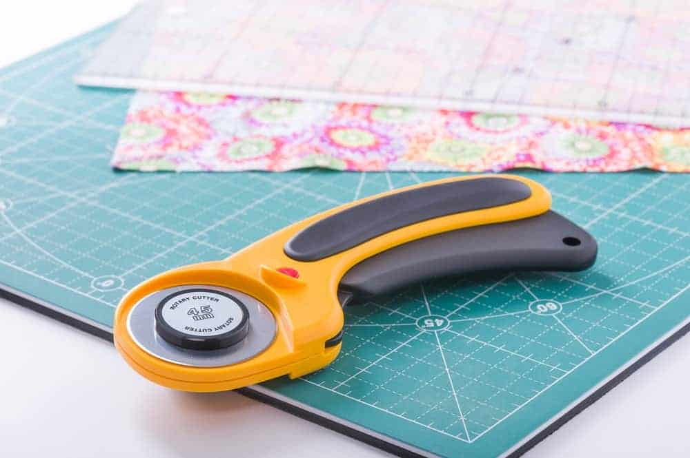 A close look at a rotary cutter on a cutting pad.