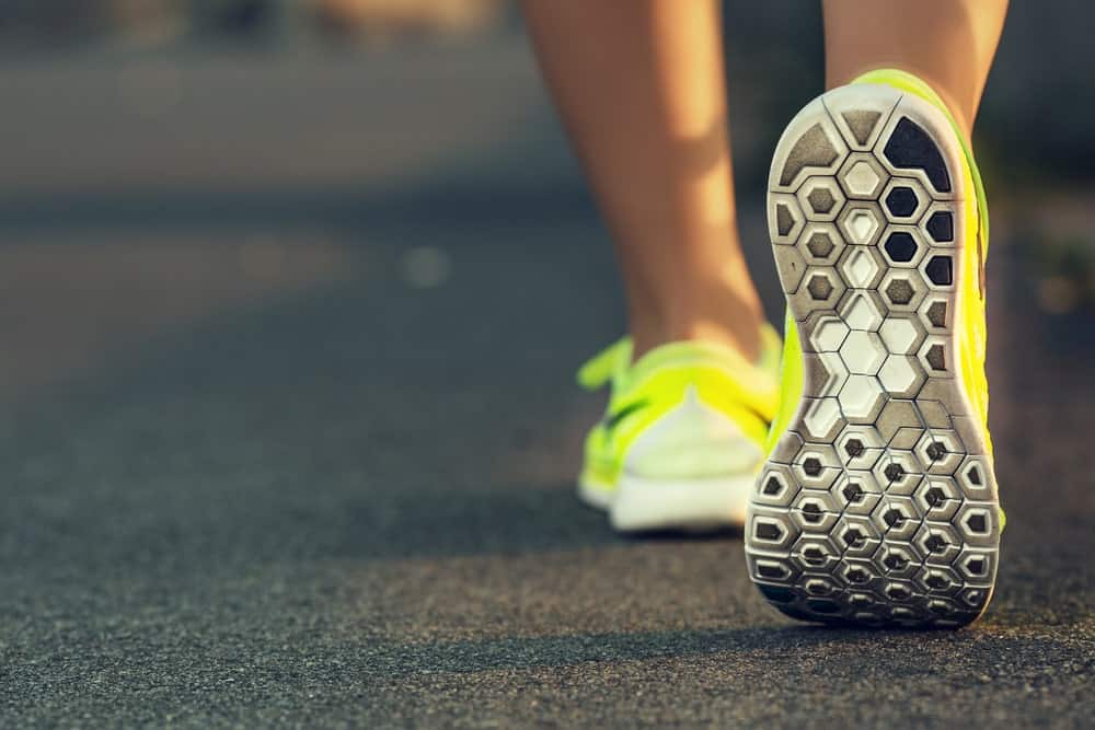 A close look at a woman wearing road running shoes.