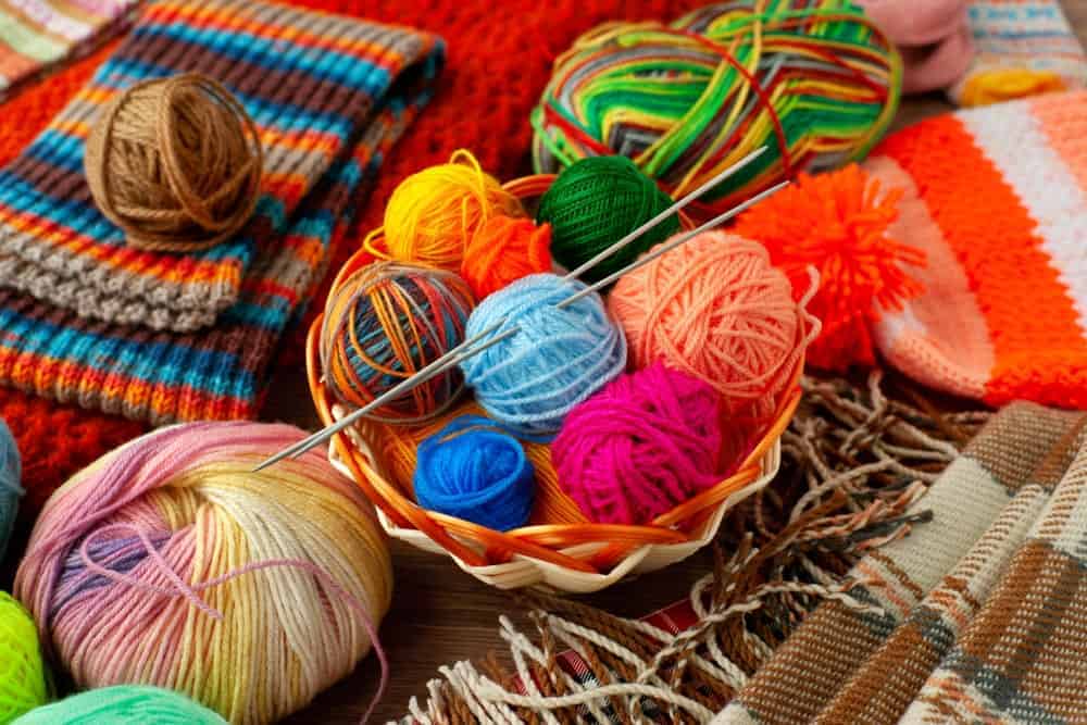 This is a close look at various spools of yarn as well as knitted products.