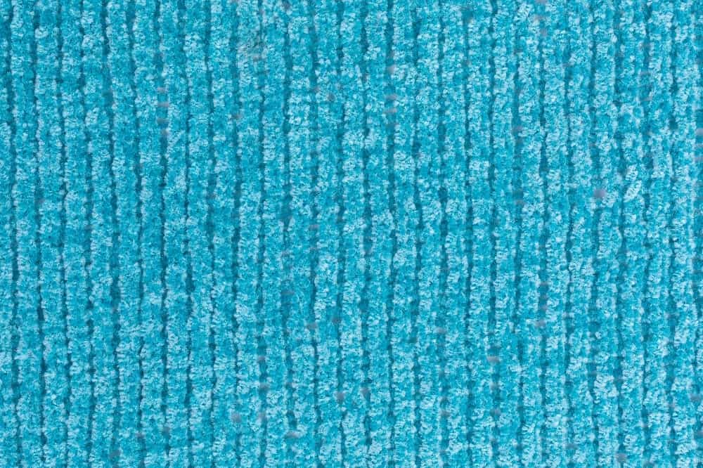 A close look at a bright blue chenille yarn cloth.