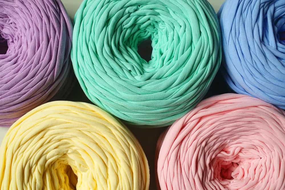 Rolls of colorful ribbon yarn.