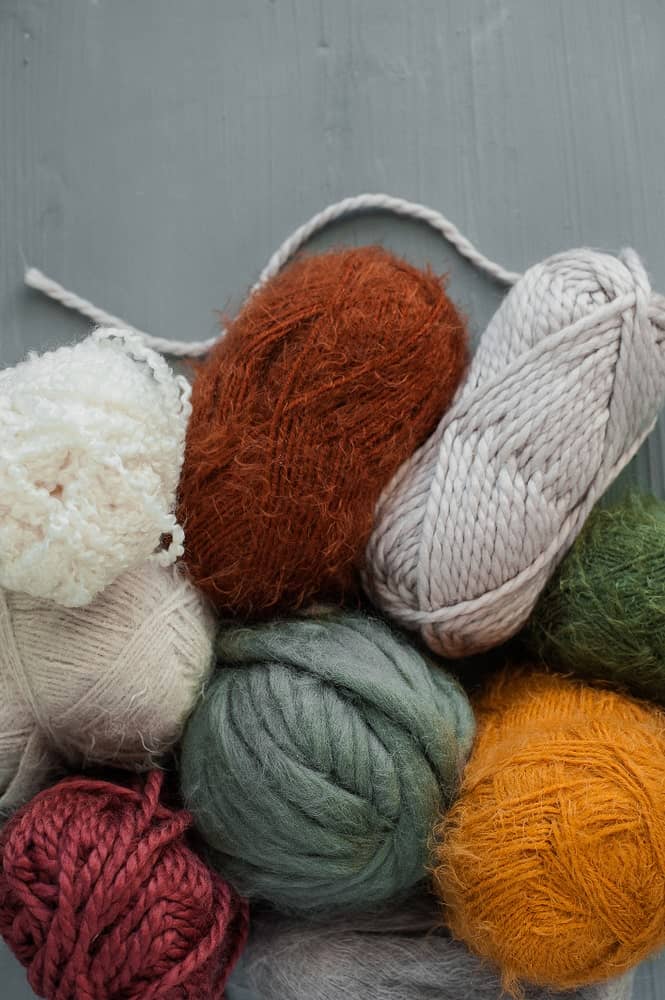 Balls of wool blend yarns in different colors.