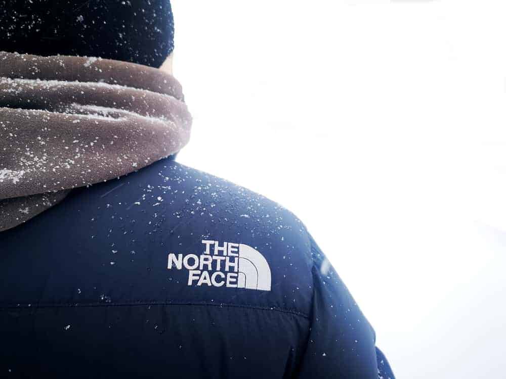Back profile of a man wearing The North Face jacket.