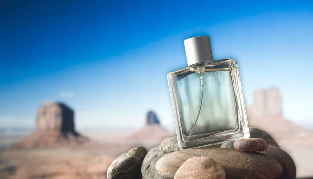 A perfume bottle on rocks.
