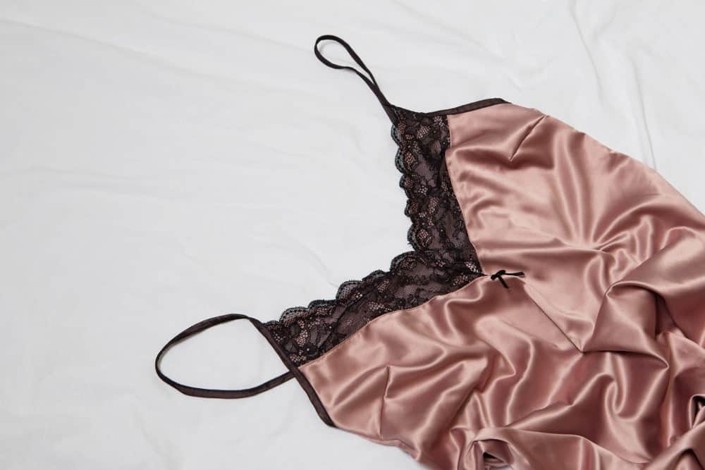 A close look at a pink silk camisole with spaghetti straps.