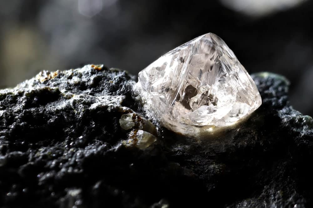 A close look at a natural diamond still embedded in a rock.