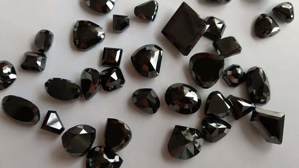 A look at a bunch of treated black polished diamonds.