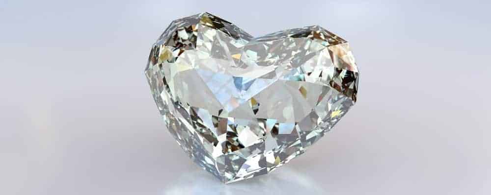 A close look at a heart-shaped diamond on a white surface.