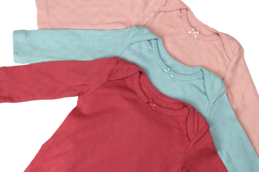 A close look at three pairs of colorful on-piece shirts with sleeves.